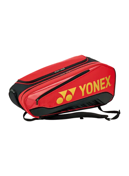 Yonex Expert Racquet Bag 6 BAG02526 in Red/Black with multiple zippered compartments, backpack straps and yellow Yonex logo