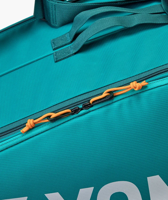 Yonex Pro Racquet Bag 6 BA92426 in Teal Green close-up showing zippered compartment with orange zipper pulls