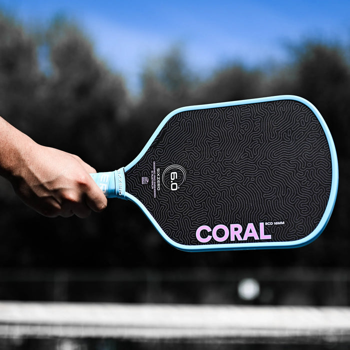 Six Zero Coral Lightweight Hybrid in Misty Blue, paddle held on court