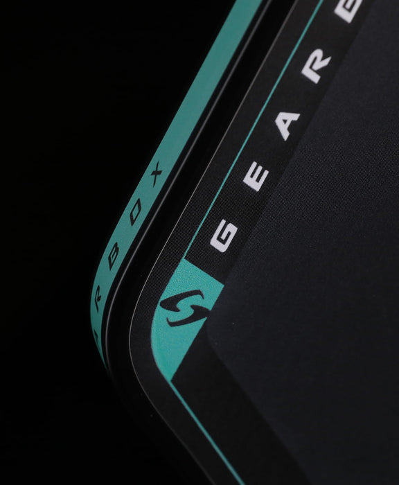 Close-up of the Gearbox Pressure X 8M paddle's textured carbon face and teal side branding