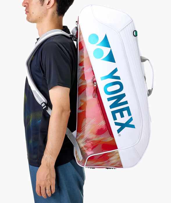 Yonex Expert Racquet Bag 6 PCS in white red worn as a backpack for carrying badminton equipment