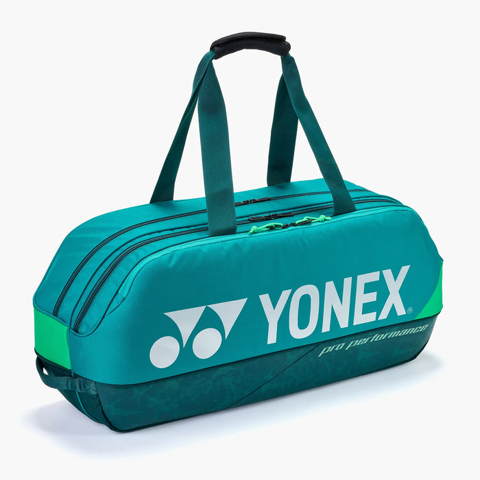 Yonex Pro Tournament Bag BA92431W Dark Green angled side view with padded carry handles, multiple zippered compartments and white Yonex branding