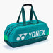 Yonex Pro Tournament Bag BA92431W Dark Green angled side view with padded carry handles, multiple zippered compartments and white Yonex branding