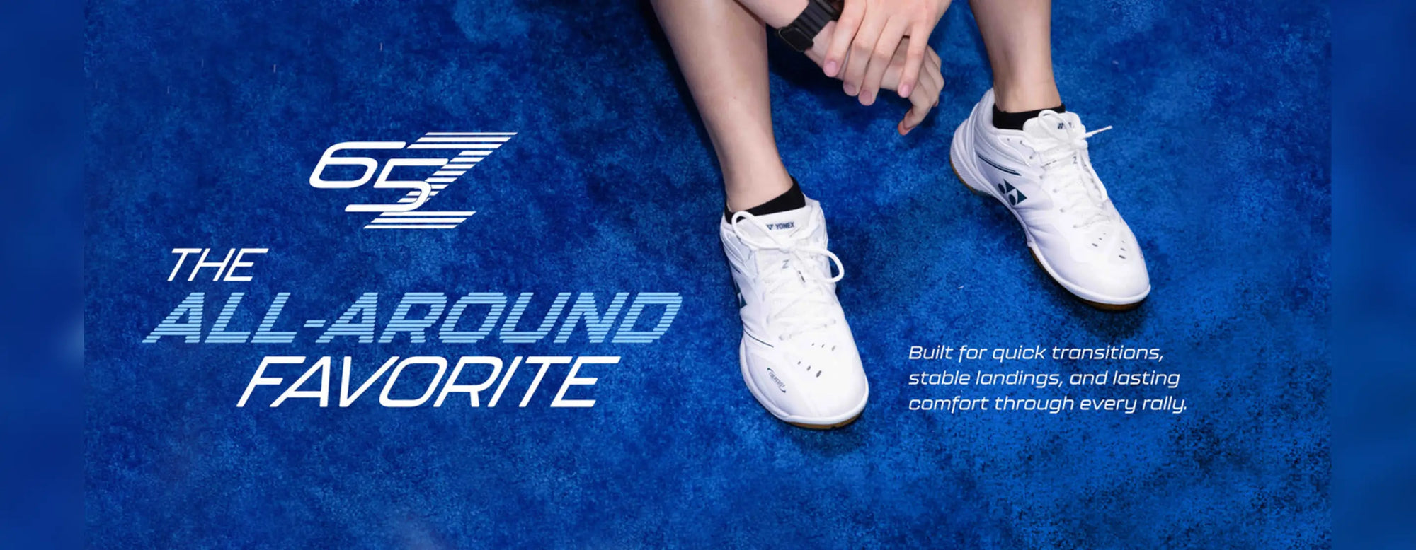 Yonex Power Cushion 65 Z4 white badminton shoes worn on a blue court